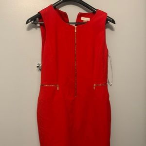 This Calvin Klein dress is red with no sleeves. Dress does not zip in the front